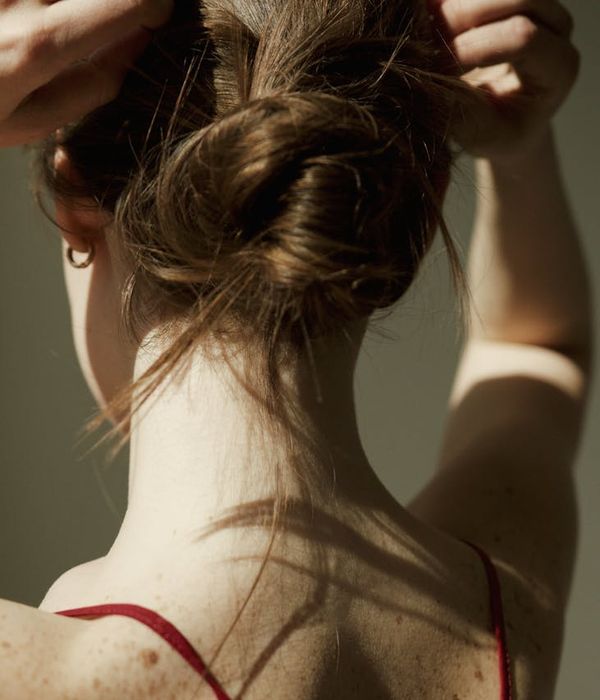 Person in a calm, seated pose with soft lighting, suggesting tranquility.